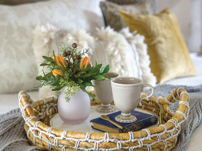 tea cup on tray on bed