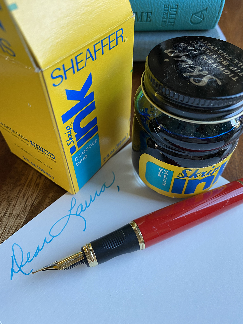 Dear Laura written in peacock blue ink with a fountain pen